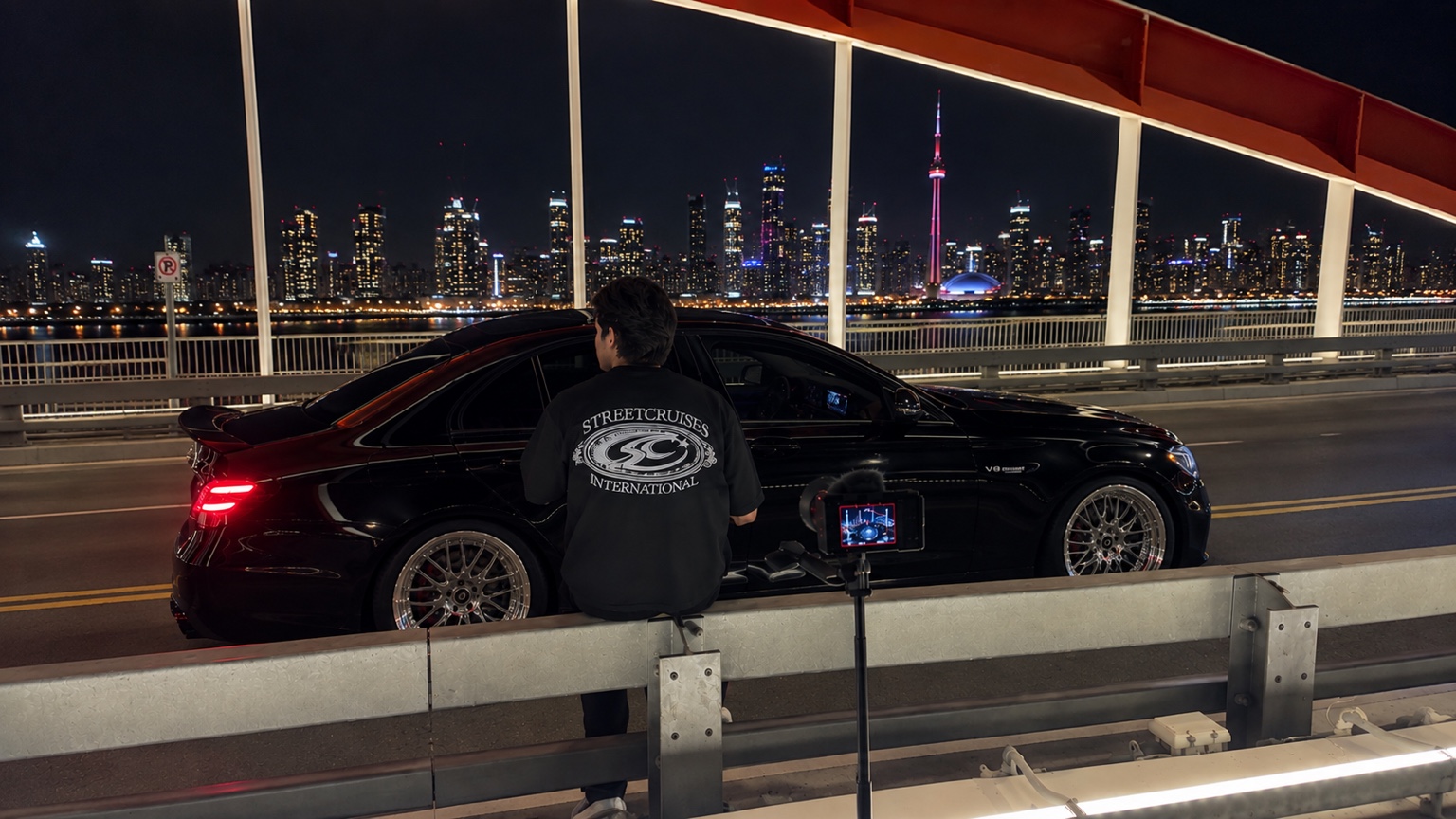 Streetcruises filming a Mercedes-AMG E63 with the Toronto skyline and CN Tower behind
